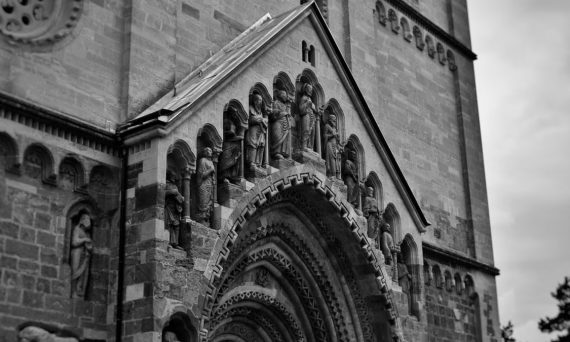 Vintage-style photograph capturing the intricate details of Ják Church's façade in Hungary.